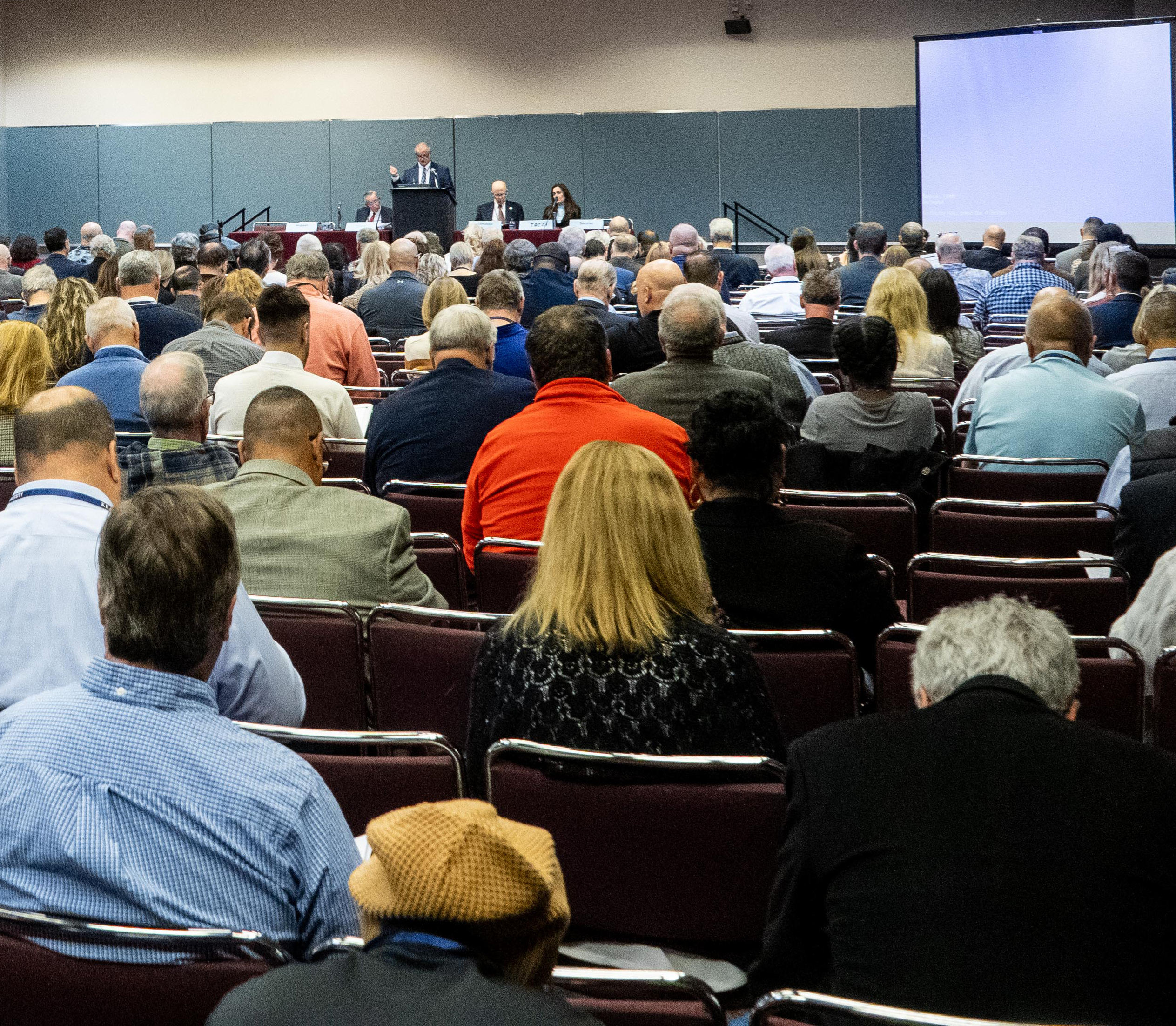 Attendees listening to panelist speak at Conference session.